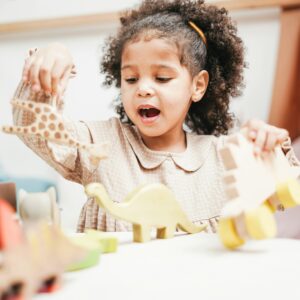 Girl Holding Wooden Toy is Singing
